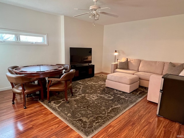 living room with hardwood / wood-style flooring and ceiling fan