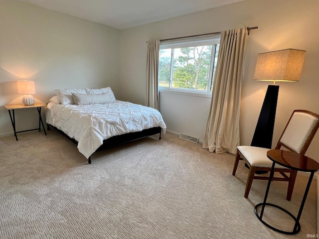 bedroom featuring light carpet