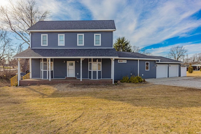 view of front facade featuring a garage, a front yard, and covered porch