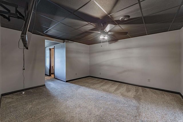 empty room with ceiling fan, carpet, and a drop ceiling