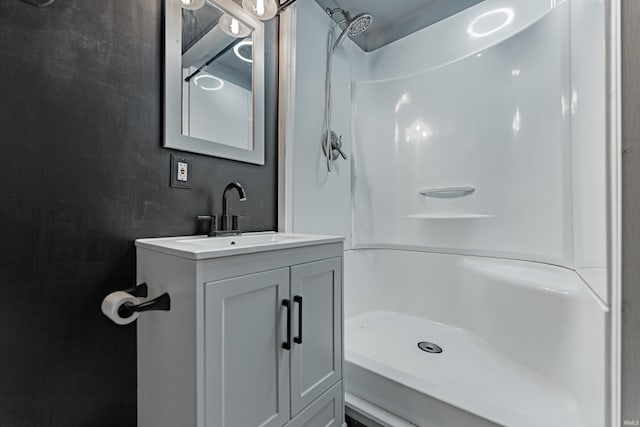 bathroom with vanity and a shower