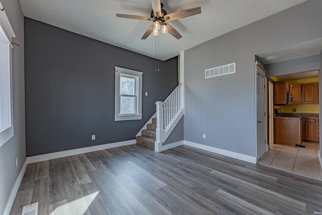 empty room featuring ceiling fan and light wood-type flooring