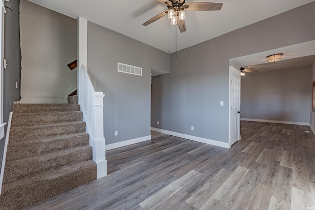 empty room with hardwood / wood-style floors and ceiling fan