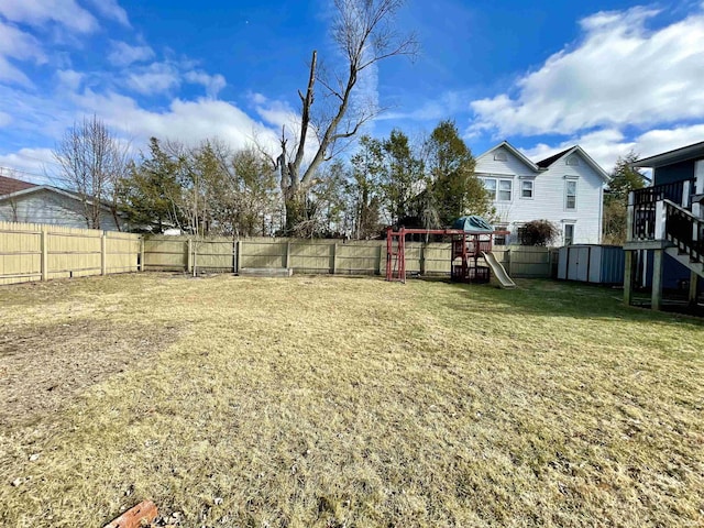 view of yard featuring a playground and a storage unit