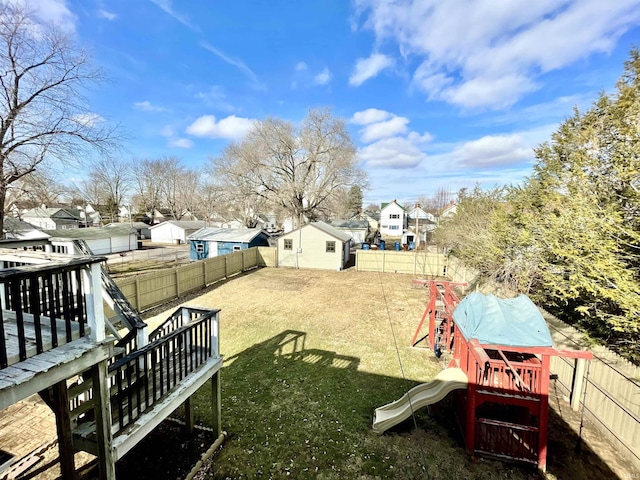 view of yard featuring a playground and a wooden deck