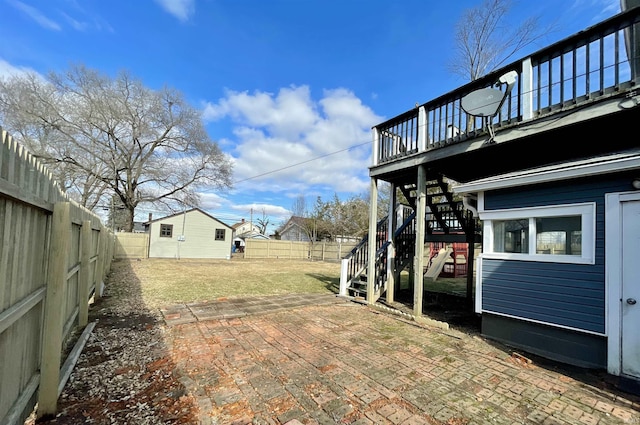 view of yard with a wooden deck and a patio area