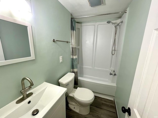 full bathroom with sink, hardwood / wood-style floors, shower / bathtub combination with curtain, and toilet