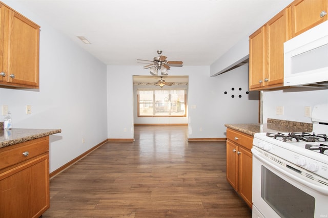 kitchen with dark hardwood / wood-style flooring, white appliances, ceiling fan, and stone countertops