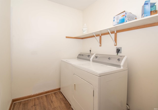 laundry area with wood-type flooring and independent washer and dryer