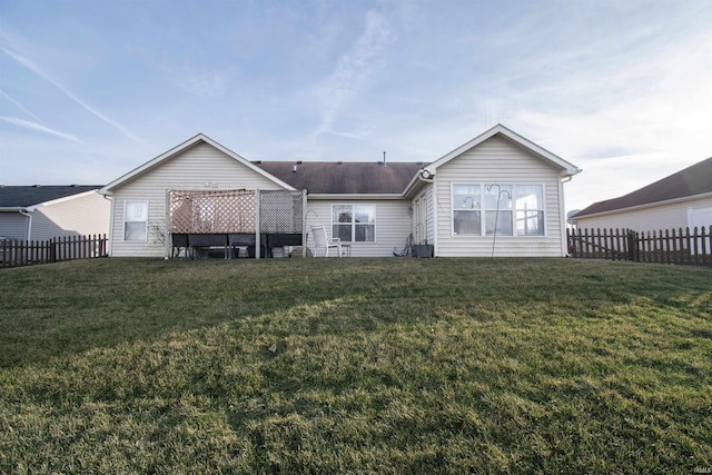 back of property with a lawn and central air condition unit