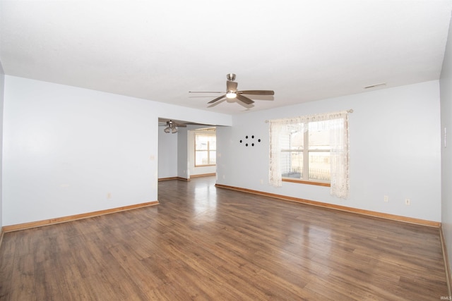 unfurnished room with dark hardwood / wood-style flooring and ceiling fan