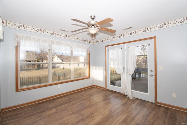 unfurnished room featuring ceiling fan and dark hardwood / wood-style flooring