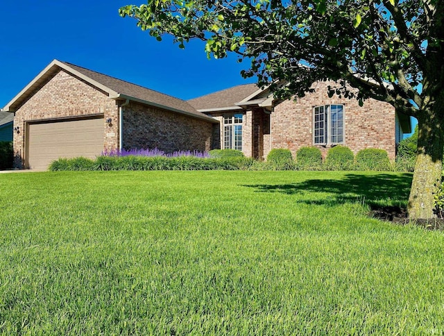 view of front of home featuring a garage and a front lawn