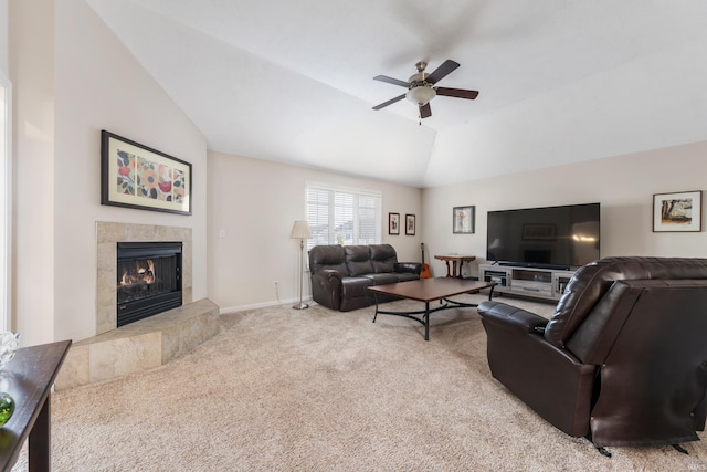 living room featuring light carpet, a fireplace, vaulted ceiling, and ceiling fan