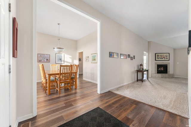 interior space with vaulted ceiling and dark hardwood / wood-style floors