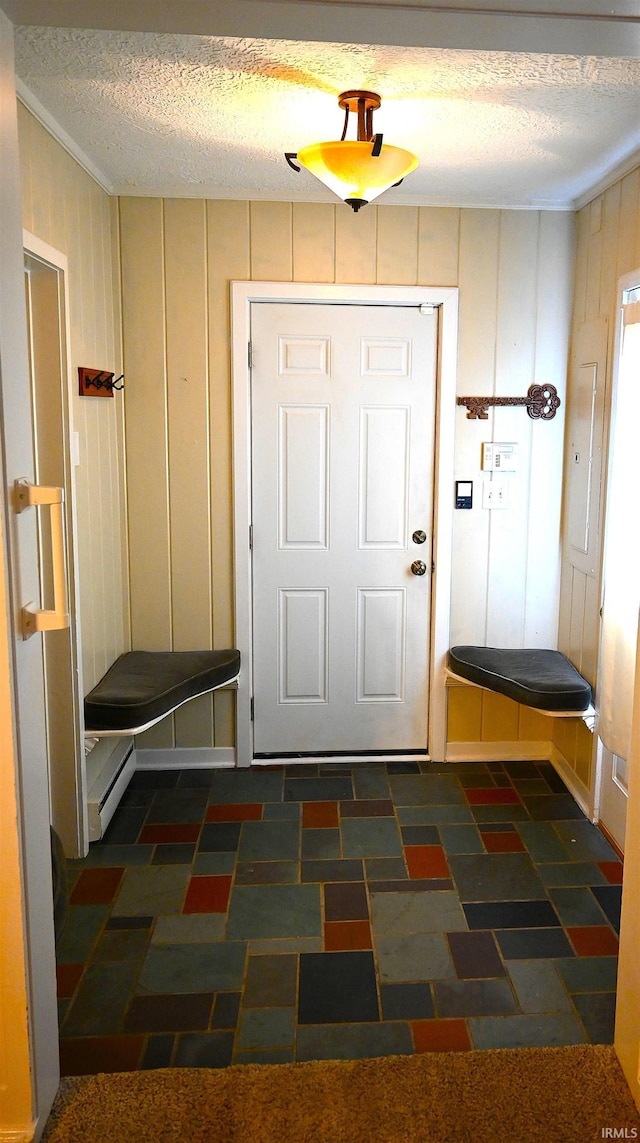 mudroom featuring baseboard heating and a textured ceiling