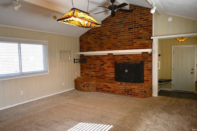 unfurnished living room featuring carpet floors, vaulted ceiling with beams, ceiling fan, and a fireplace