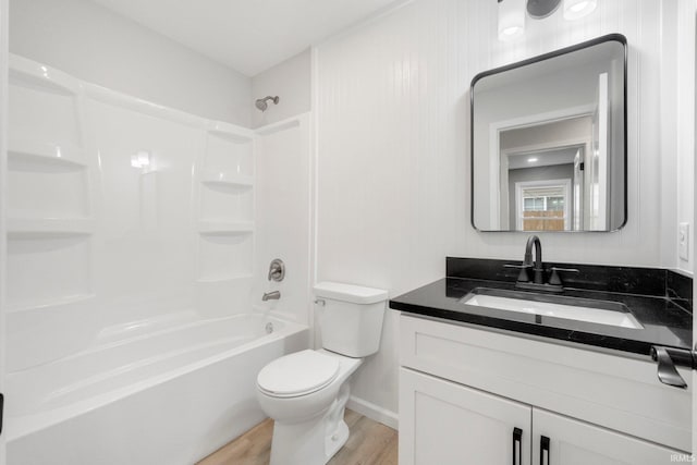 full bathroom featuring hardwood / wood-style flooring, toilet, vanity, and  shower combination