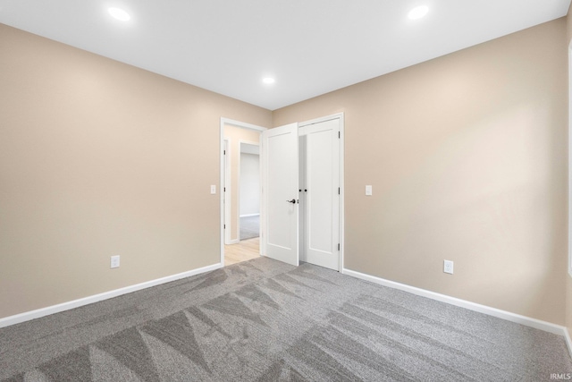 unfurnished room with light carpet