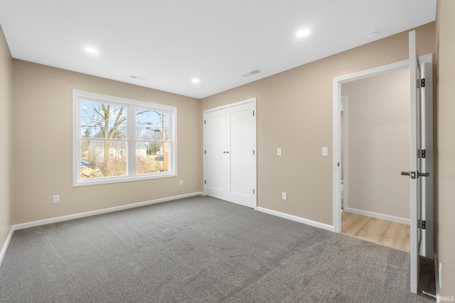 unfurnished bedroom featuring a closet and carpet