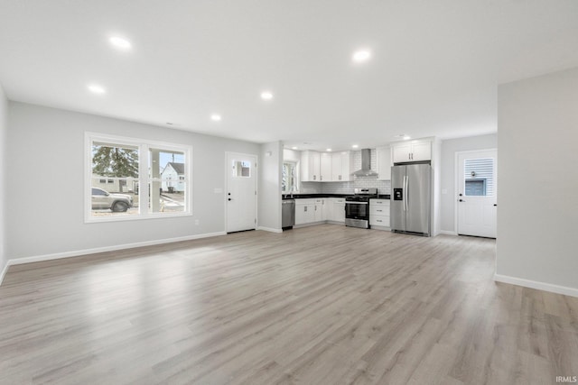 unfurnished living room with light hardwood / wood-style flooring