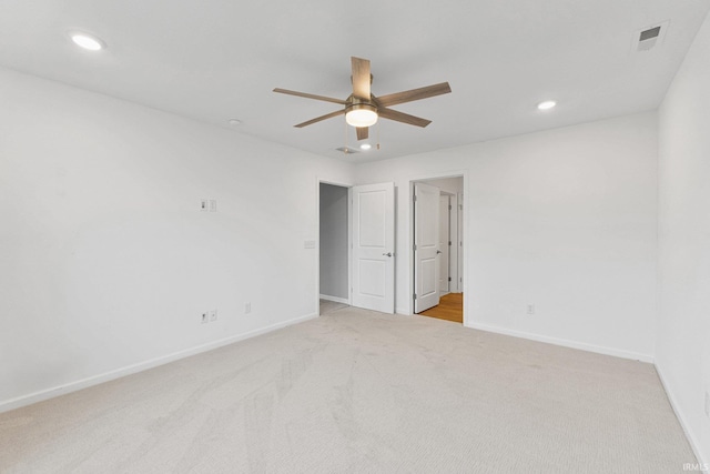 unfurnished room with light carpet and ceiling fan