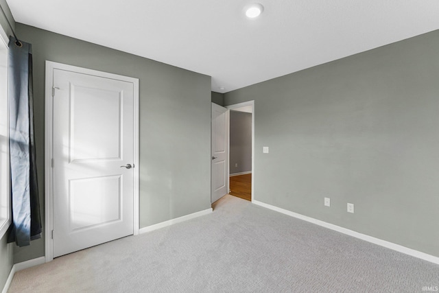 unfurnished bedroom featuring light colored carpet