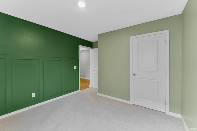 unfurnished bedroom with light colored carpet