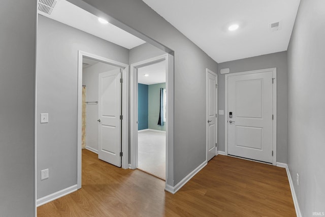 hall with hardwood / wood-style floors