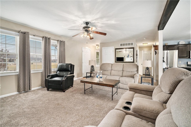 carpeted living room featuring ceiling fan