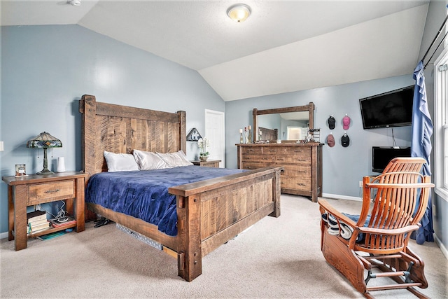 carpeted bedroom with lofted ceiling