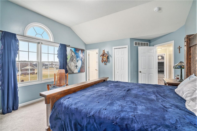 carpeted bedroom with lofted ceiling