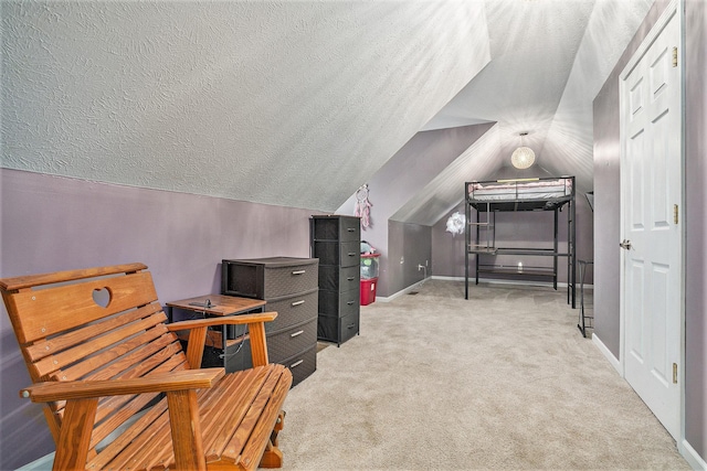 office space with light colored carpet, vaulted ceiling, and a textured ceiling