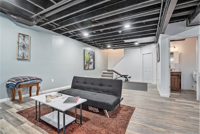 living room with wood-type flooring and sink