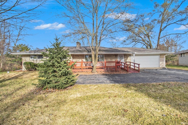 ranch-style house featuring a garage and a front lawn