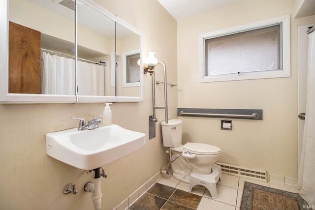 bathroom with tile patterned flooring, a baseboard radiator, sink, and toilet