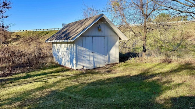 view of outbuilding with a yard