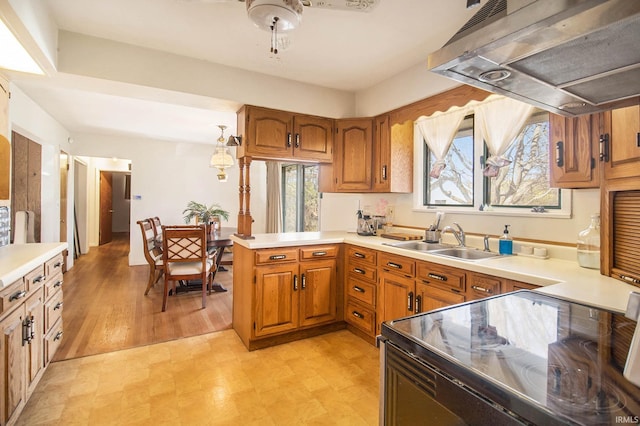 kitchen with sink, hanging light fixtures, range hood, black range with electric cooktop, and kitchen peninsula