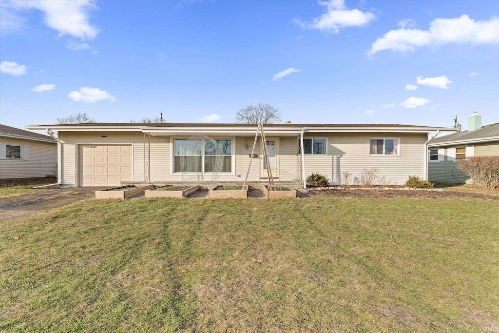 single story home with a garage and a front lawn