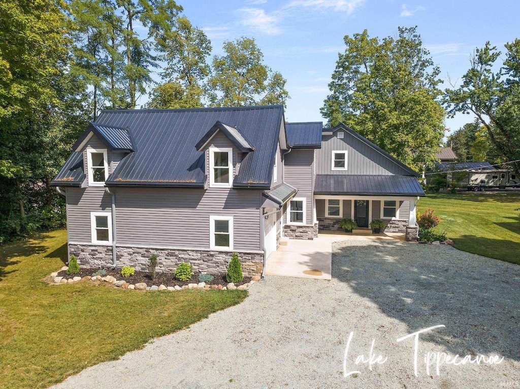 view of front of home featuring a garage, a front lawn, and a porch