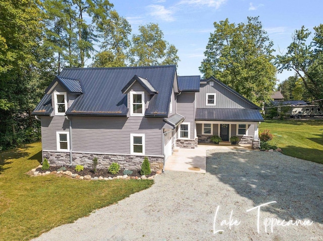 view of front of home featuring a garage, a front lawn, and a porch