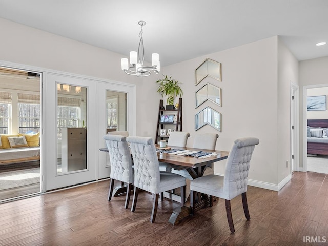 dining room featuring dark hardwood / wood-style floors and a chandelier