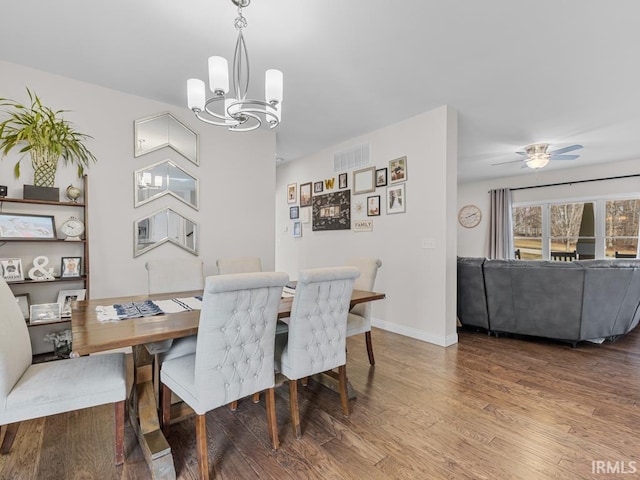 dining room featuring wood-type flooring and ceiling fan with notable chandelier