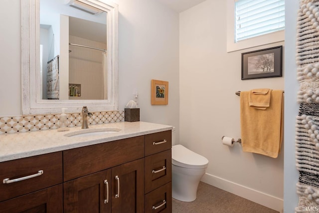 bathroom featuring walk in shower, vanity, and toilet