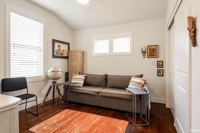 living room with dark wood-type flooring, ceiling fan, and lofted ceiling