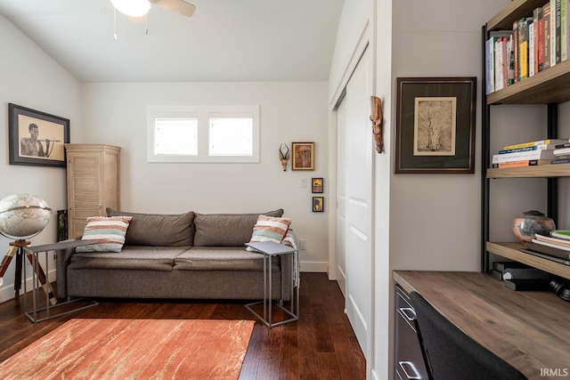 living room featuring dark hardwood / wood-style flooring and ceiling fan