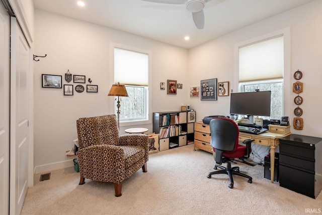 office space with light colored carpet and ceiling fan