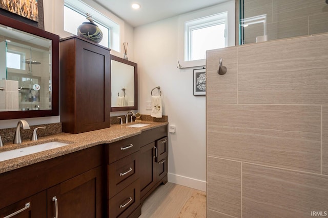 bathroom with vanity, a shower with shower door, and hardwood / wood-style floors