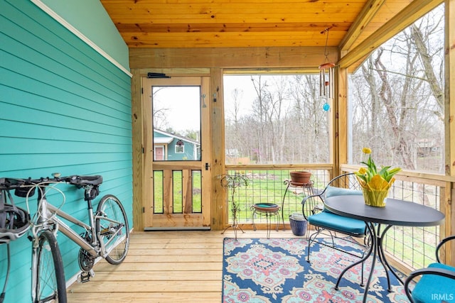 sunroom / solarium featuring vaulted ceiling and wooden ceiling