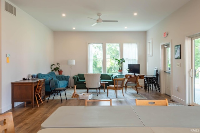 living room featuring hardwood / wood-style floors and ceiling fan